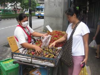 Sue buying mankoot from her favorite fruit vendor on the soi.