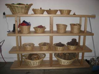 Each toy has its own space, and many are ojects like seashells and pine cones collected from nature. The bottom two baskets are filled with blocks made from sections of treetrunks and branches.