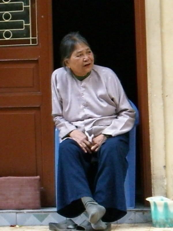 Old woman watching Hanoi street life